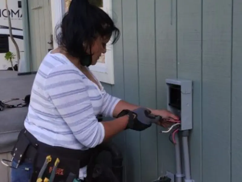 Licensed electrician wiring an exterior subpanel in Black Forest